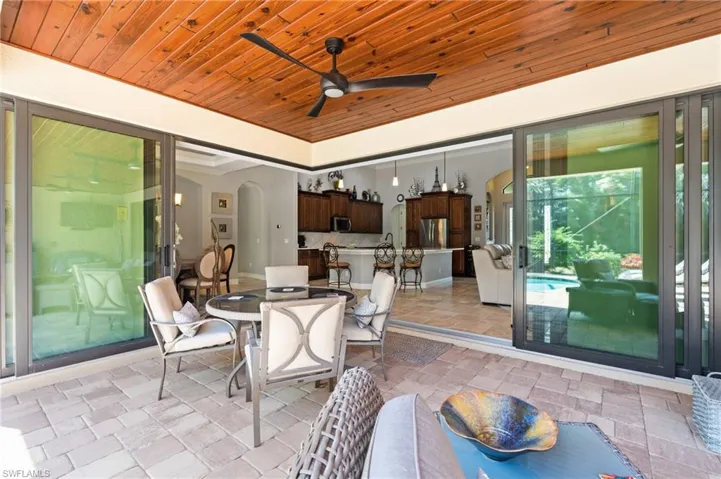 View of patio with outdoor dining space and ceiling fan