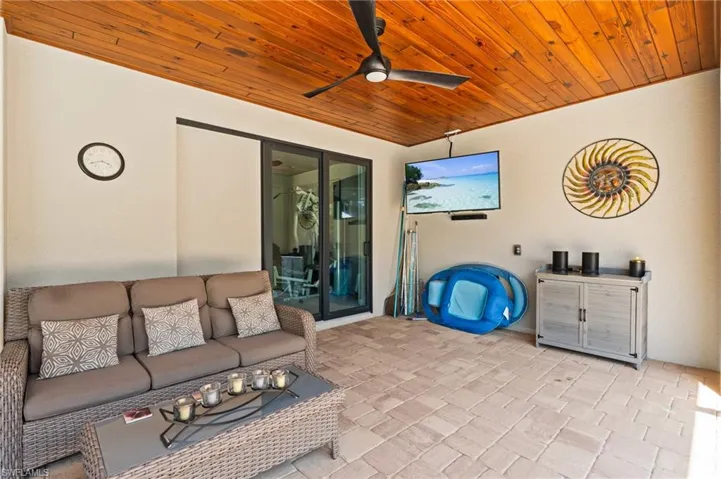 View of patio with ceiling fan and an outdoor hangout area