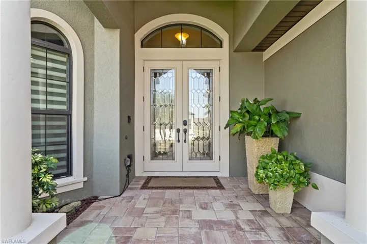 Doorway to property with french doors and stucco siding