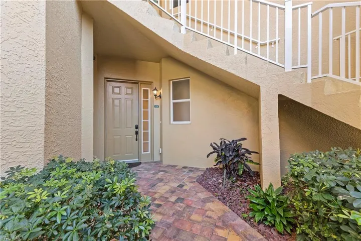 Doorway to property with stucco siding