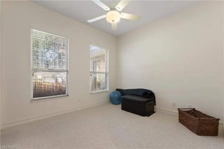 Unfurnished room featuring carpet and ceiling fan