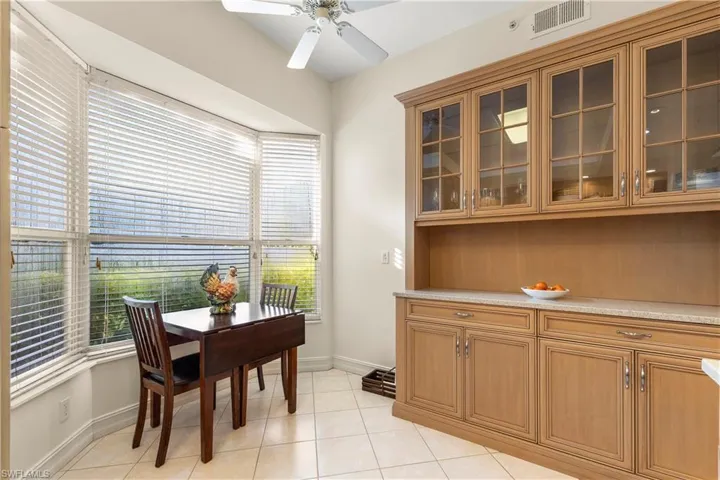 Dining room with light tile patterned flooring and ceiling fan
