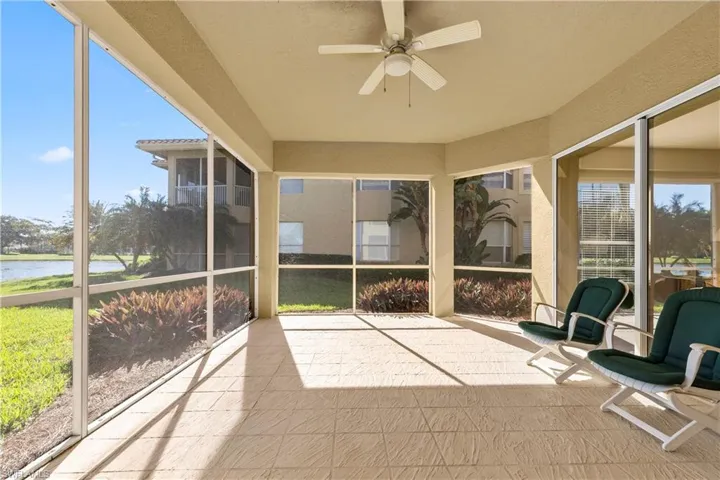 Sunroom / solarium with a water view and ceiling fan