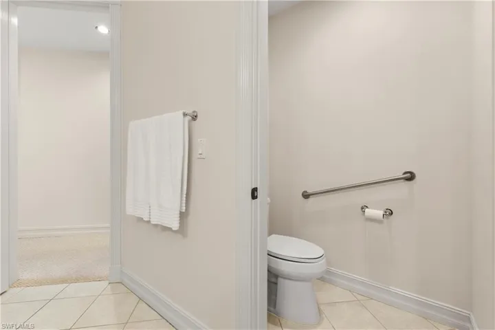 Bathroom with baseboards and light tile patterned flooring