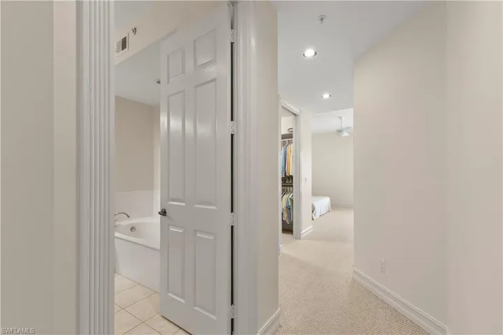 Priamry Bedroom Hallway featuring recessed lighting, light carpet, and light tile patterned flooring