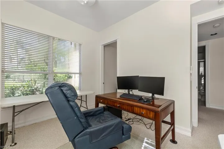 Office area with light colored carpet and baseboards