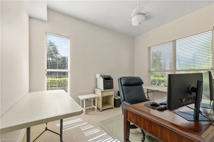 Office space with carpet floors and ceiling fan