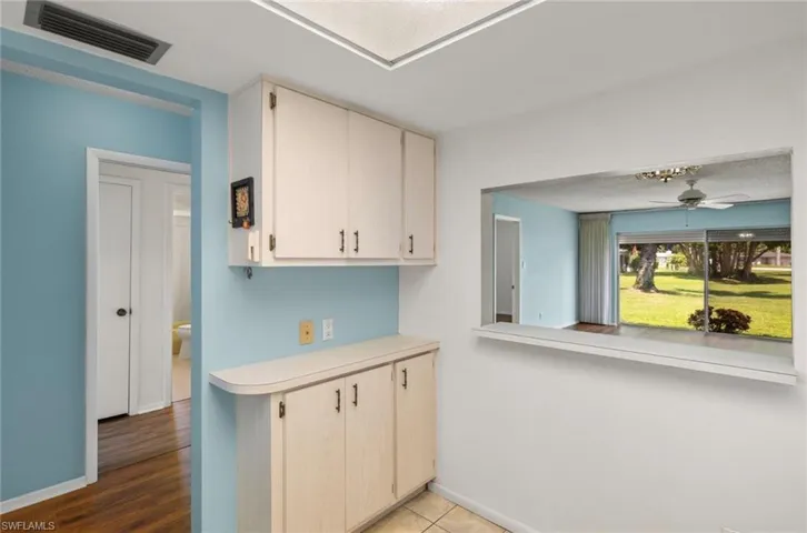 Kitchen with ceiling fan and wood-type flooring