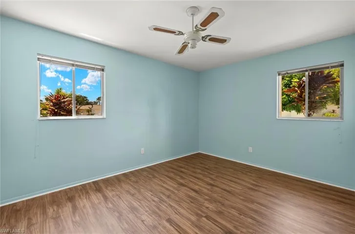 Unfurnished room featuring ceiling fan and wood-type flooring