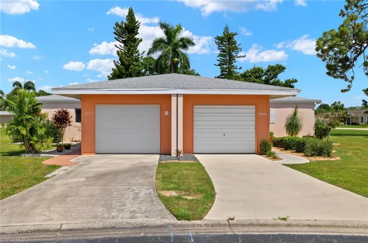View of front of home featuring a front lawn and a garage