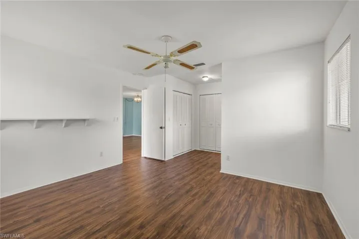 Unfurnished room with ceiling fan and hardwood / wood-style floors