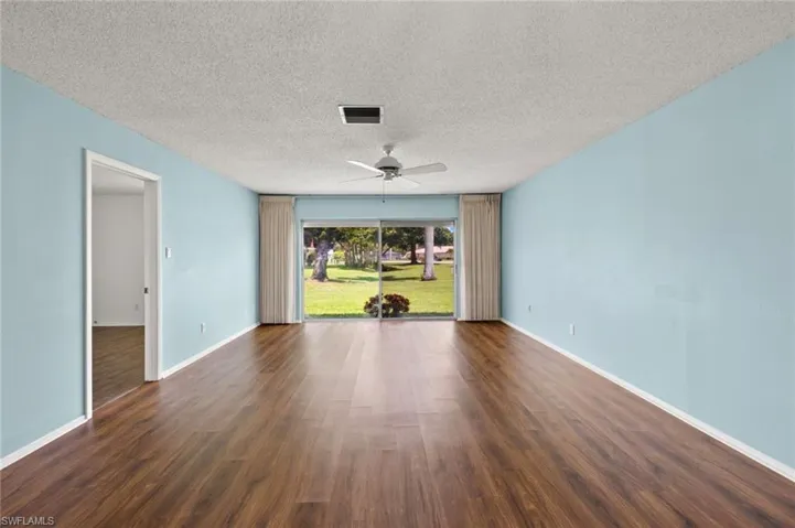 Spare room featuring a textured ceiling, ceiling fan, and hardwood / wood-style floors