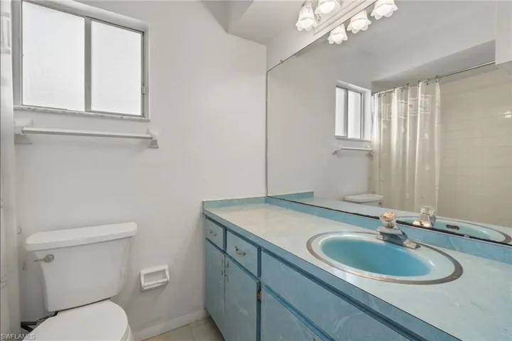 Bathroom with tile patterned flooring, toilet, and vanity