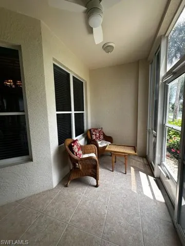 Sunroom with a textured wall and tile patterned flooring