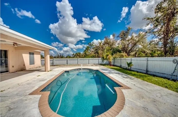 View of swimming pool with a patio area and a fenced backyard