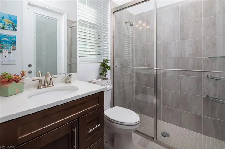 Full bath featuring vanity and a shower stall