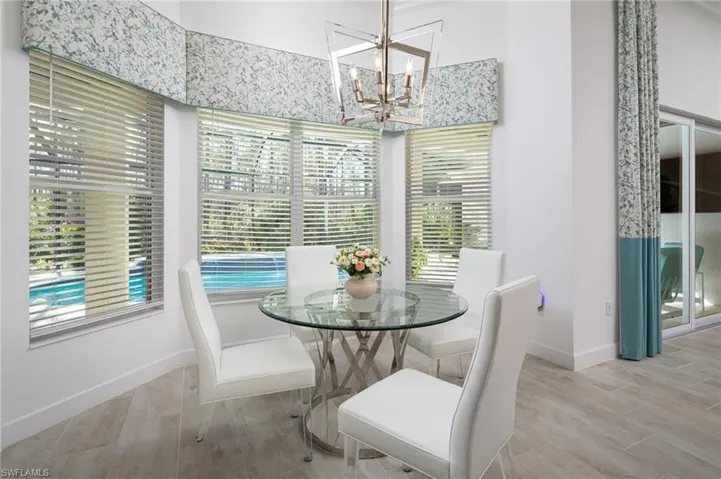 Dining space featuring wood tiled floors and a chandelier