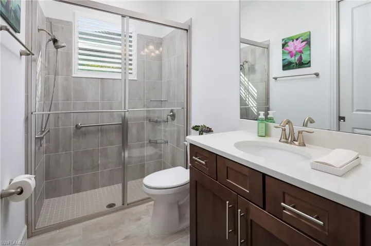 Full bath featuring vanity and a shower stall