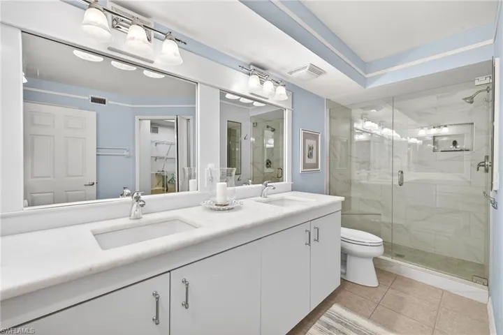Primary Bathroom Dual vanity with undermount sinks and white countertops