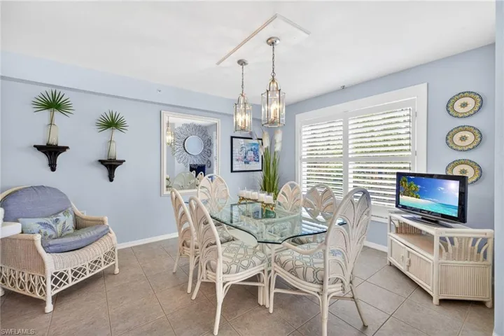 Dining area featuring light blue walls and neutral tile flooring