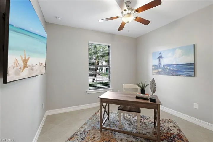 Bedroom four, situated across the hall from bedroom three, offers a comparable size along with tile flooring and a ceiling fan.