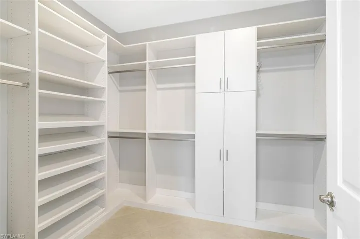 Generously sized walk-in closet with custom built-ins for all your storage needs.