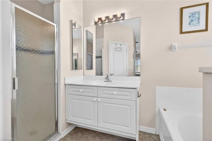 PRIVATE BATHROOM FOR PRIMARY BEDROOM. LARGE SHOWER, TOILET HAS PRIVACY DOOR, TWO SEPARATE VANITES, AND SOAKING TUB.