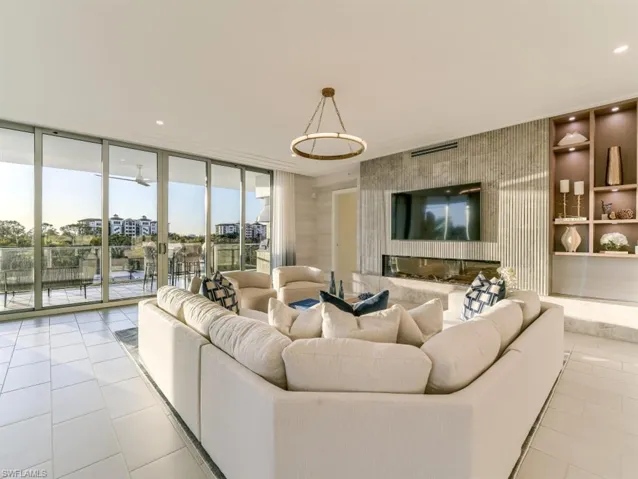 Living room with floor to ceiling windows, recessed lighting
