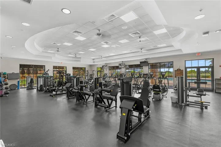 Spacious fitness center featuring various exercise equipment and lots of natural light