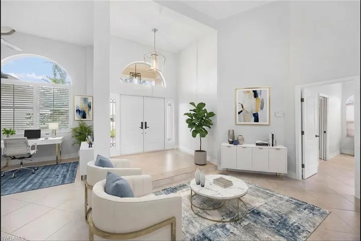 Foyer entrance featuring light tile patterned floors and high vaulted ceiling