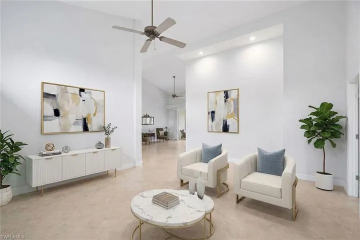 Living area featuring ceiling fan, high vaulted ceiling, and recessed lighting