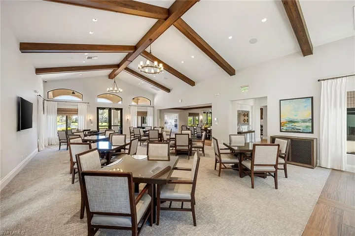 Dining space with high vaulted ceiling, recessed lighting, a chandelier, beam ceiling, and radiator heating unit