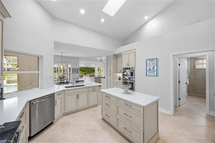 Kitchen featuring stainless steel appliances, cream cabinetry, a skylight, healthy amount of natural light, and recessed lighting