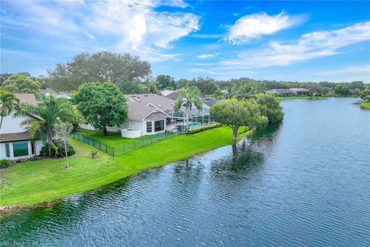 Aerial view of property and surrounding area featuring a nearby body of water