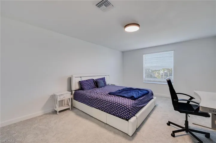 Bedroom with a desk and carpet flooring
