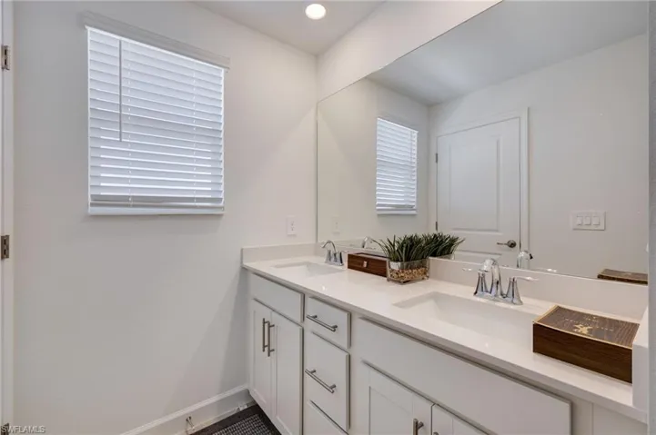 Bathroom featuring double vanity and recessed lighting