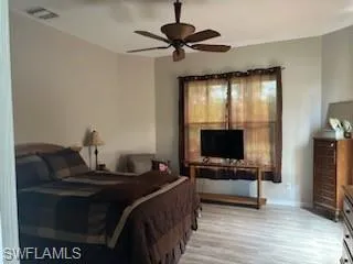 Bedroom with light wood-style flooring and ceiling fan