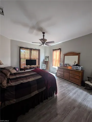 Bedroom featuring wood finished floors and a ceiling fan