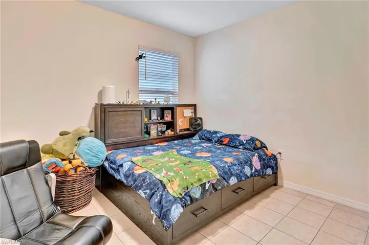 Bedroom with light tile floors
