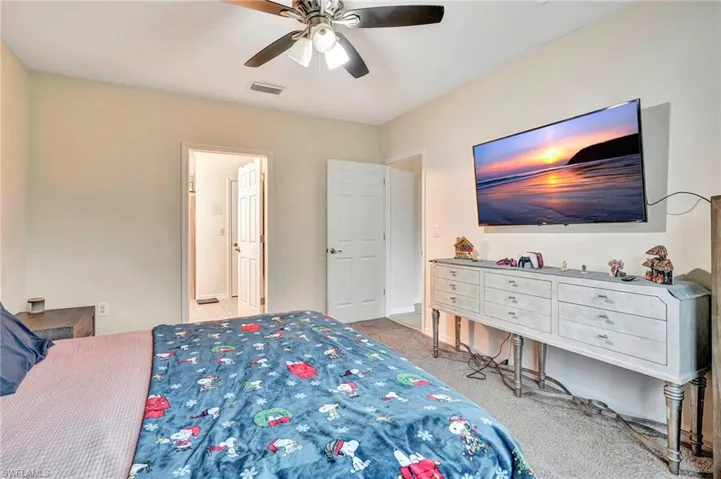 Bedroom featuring ceiling fan and carpet floors