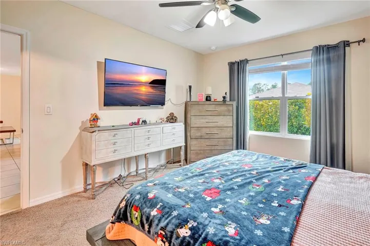 Bedroom with carpet and ceiling fan