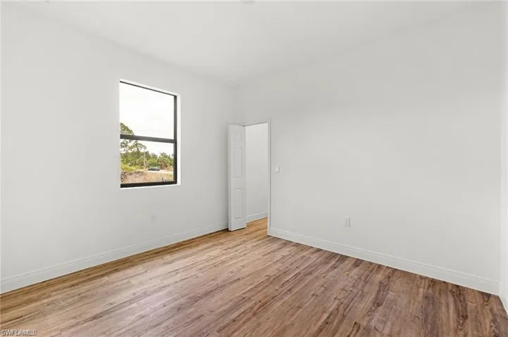 Empty room with light hardwood / wood-style flooring