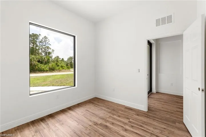Empty room with light hardwood / wood-style flooring