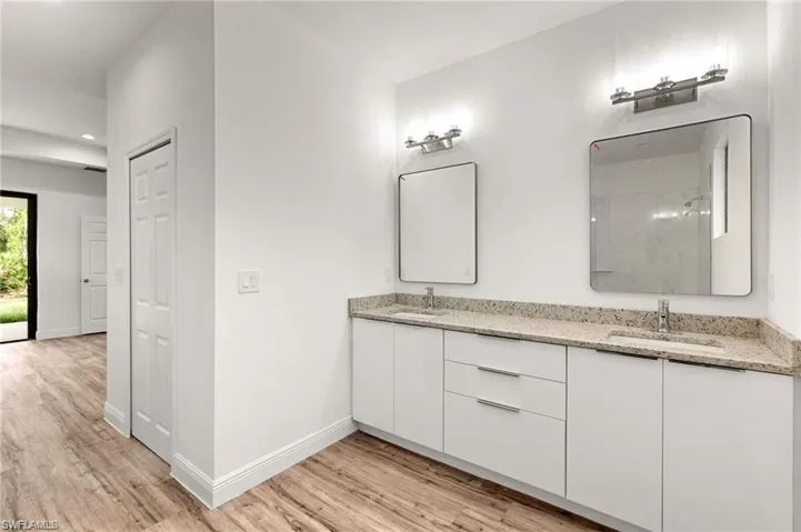 Bathroom with wood-type flooring and double sink vanity