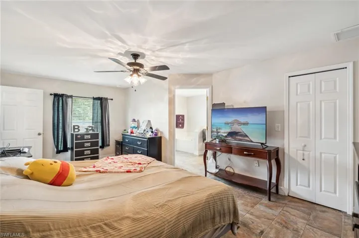 Tiled bedroom with ceiling fan