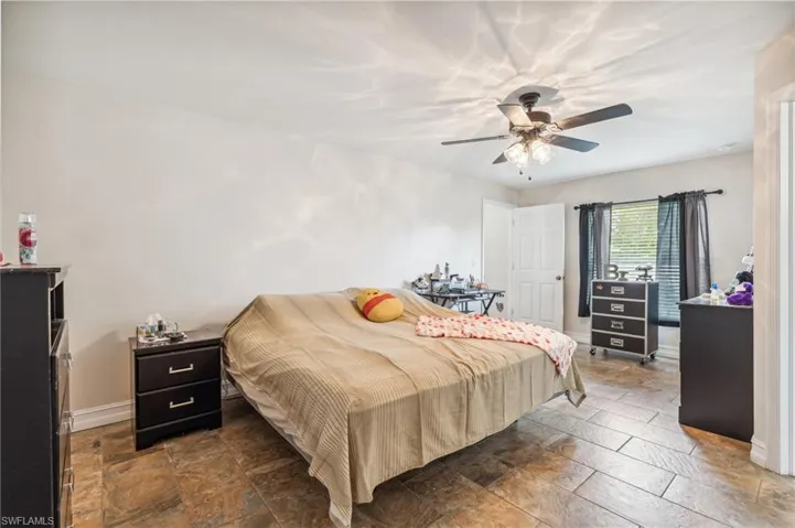 Bedroom featuring ceiling fan and tile patterned flooring