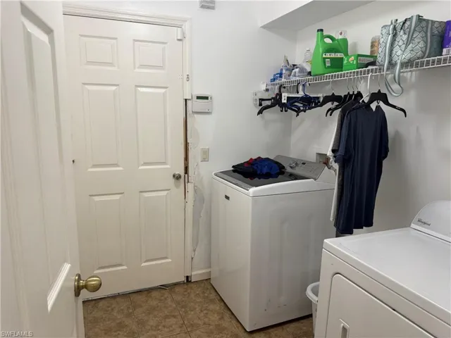 Laundry room featuring independent washer and dryer with damaged door and door frame