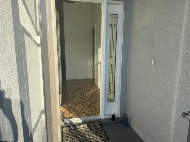 Property front entrance inside of screened porch