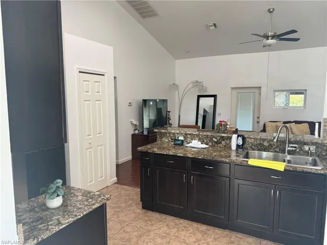 kitchen view from dining area, double sink, pantry and light tile patterned