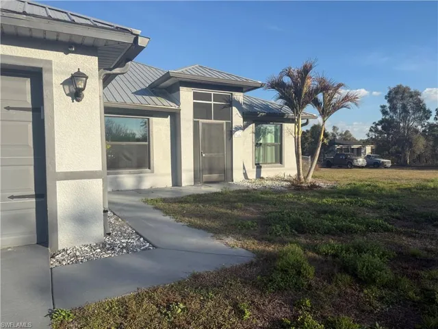 View of exterior entry featuring screened porch.
